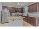 Modern kitchen featuring granite countertops, stainless steel appliances, and a functional island with a sink at 410 South Hudson St, Orlando, FL 32835
