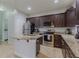 Well-equipped kitchen with stainless steel appliances, granite countertops, and a center island with seating and sink at 410 South Hudson St, Orlando, FL 32835