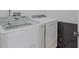 Convenient laundry room with modern, white, front-loading washer and dryer at 410 South Hudson St, Orlando, FL 32835
