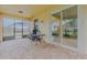 Back patio featuring brick floor, grill, exterior ceiling fan and screened enclosure, and view to yard at 410 South Hudson St, Orlando, FL 32835
