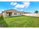 Large backyard with healthy green grass and a white vinyl fence at 432 Tallow Wood Cir, Debary, FL 32713