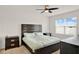Bright bedroom with a dark wooden bed frame, light bedding, and natural light at 432 Tallow Wood Cir, Debary, FL 32713