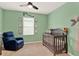 Cozy Bedroom featuring green walls, crib, and -friendly decorative elements at 432 Tallow Wood Cir, Debary, FL 32713