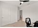 Bedroom with neutral carpet, ceiling fan and white door at 432 Tallow Wood Cir, Debary, FL 32713