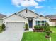 Attractive single-story home showcasing a two-car garage, lush lawn, and inviting curb appeal at 432 Tallow Wood Cir, Debary, FL 32713