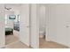 Hallway leading to the bedroom with view of the walk-in closet and adjacent toilet room at 432 Tallow Wood Cir, Debary, FL 32713