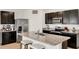 Modern kitchen featuring granite countertops, stainless steel appliances, and dark wood cabinets at 432 Tallow Wood Cir, Debary, FL 32713