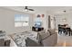 Cozy living room with a comfortable sofa, ceiling fan, and a view to the dining area at 432 Tallow Wood Cir, Debary, FL 32713