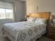 Inviting bedroom featuring a comfortable bed, soft carpet, and natural light from the window at 4419 S Semoran Blvd # 7, Orlando, FL 32822