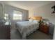 Inviting bedroom featuring a comfortable bed, soft carpet, and natural light from the window at 4419 S Semoran Blvd # 7, Orlando, FL 32822