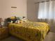 Bright bedroom featuring a yellow comforter, soft carpet, and natural light at 4419 S Semoran Blvd # 7, Orlando, FL 32822