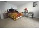 Cozy bedroom with tiger-striped blanket, neutral walls, and carpet floors at 4419 S Semoran Blvd # 7, Orlando, FL 32822