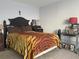 Cozy bedroom with tiger-striped blanket, neutral walls, and carpet floors at 4419 S Semoran Blvd # 7, Orlando, FL 32822