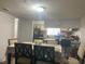 Formal dining room boasts wood floors, a large decorative dining table and a view into the kitchen at 4419 S Semoran Blvd # 7, Orlando, FL 32822