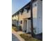 Well-maintained white building featuring stucco walls and black trim detail and neatly landscaped yard at 4419 S Semoran Blvd # 7, Orlando, FL 32822