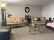 Spacious living room features plush carpeting, neutral paint, ample seating and a glass coffee table at 4419 S Semoran Blvd # 7, Orlando, FL 32822