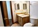 Compact bathroom featuring a vanity with wooden cabinet, a mirror, and a toilet at 4516 Summergrove Ave, Orlando, FL 32812
