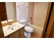 Cozy bathroom with a tiled shower-tub, toilet, and a vanity with a wooden cabinet at 4516 Summergrove Ave, Orlando, FL 32812