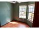 Bright bedroom with wood floors, two windows for natural light, and neutral accents at 4516 Summergrove Ave, Orlando, FL 32812
