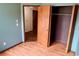 Cozy bedroom with hardwood floors, blue walls, and a convenient closet with sliding doors at 4516 Summergrove Ave, Orlando, FL 32812