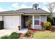 Charming single-story home with a one car garage, well-kept lawn, and colorful landscaping at 4516 Summergrove Ave, Orlando, FL 32812