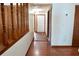 Hallway featuring wood flooring and trim, complemented by bright white walls and wood doors at 4516 Summergrove Ave, Orlando, FL 32812