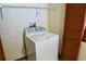The laundry room features a washing machine, wire shelving and a utility closet at 4516 Summergrove Ave, Orlando, FL 32812