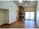 Spacious living room featuring a vaulted ceiling, brick fireplace, ceiling fan and wood floors at 4516 Summergrove Ave, Orlando, FL 32812