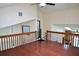 Loft area with railing overlooking the living room and hardwood floors at 4516 Summergrove Ave, Orlando, FL 32812