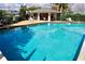 Community pool and pavilion with crystal blue water and poolside seating at 4516 Summergrove Ave, Orlando, FL 32812
