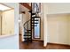 Unique black spiral staircase leads to the upper level with hardwood floors at 4516 Summergrove Ave, Orlando, FL 32812