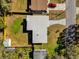 An aerial view of the home showcasing the modern roof, large yard, and adjacent garden at 4521 Jim Glenn Dr, Orlando, FL 32808