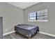 Cozy bedroom with wood-look flooring and natural light from a window at 4521 Jim Glenn Dr, Orlando, FL 32808