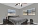 Bedroom with ceiling fan, wood-look flooring, and natural light from two windows at 4521 Jim Glenn Dr, Orlando, FL 32808