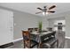 Open floorplan of the dining room, with ceiling fan, table with seating for six at 4521 Jim Glenn Dr, Orlando, FL 32808