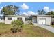 Charming single-story home showcasing a well-maintained yard and attached garage at 4521 Jim Glenn Dr, Orlando, FL 32808