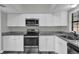 Well-lit kitchen with stainless steel appliances and white cabinets at 4521 Jim Glenn Dr, Orlando, FL 32808