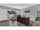Comfortable home office with wood-look floors, a work desk, and a cozy couch at 4521 Jim Glenn Dr, Orlando, FL 32808