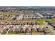 A bird's eye view of a community with homes, some equipped with solar panels at 455 Eaglecrest Dr, Haines City, FL 33844