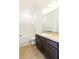 Bathroom features wood-look floors, modern vanity with a large mirror, and shower-tub combo at 455 Eaglecrest Dr, Haines City, FL 33844