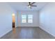Comfortable bedroom with wood-style flooring and views to an ensuite bath at 455 Eaglecrest Dr, Haines City, FL 33844