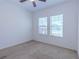 Bright bedroom with carpet flooring, two windows with blinds, and neutral wall color at 455 Eaglecrest Dr, Haines City, FL 33844