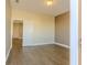 Bedroom with wood-style tile flooring; natural light streams in through the doorway at 455 Eaglecrest Dr, Haines City, FL 33844