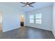Comfortable bedroom with wood-style flooring and view to a backyard at 455 Eaglecrest Dr, Haines City, FL 33844