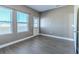 Bright bonus room with gray wood-style tile floor and ample natural light from the windows at 455 Eaglecrest Dr, Haines City, FL 33844