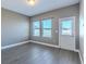 Bright bonus room with gray wood-style tile floor, a door to the backyard, and ample natural light from the windows at 455 Eaglecrest Dr, Haines City, FL 33844