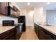 Modern kitchen featuring sleek countertops, stainless steel sink, and a view into the hall at 455 Eaglecrest Dr, Haines City, FL 33844