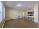 Open-concept living room featuring wood-look flooring, natural light, and seamless connection to the kitchen at 455 Eaglecrest Dr, Haines City, FL 33844