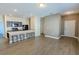 Living room featuring wood-look flooring, with an eating counter, and a view of the front door at 455 Eaglecrest Dr, Haines City, FL 33844