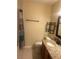 Neutral-toned bathroom with granite counter vanity, sink, toilet, and towel rack at 5323 Alcom Dr, Orlando, FL 32812